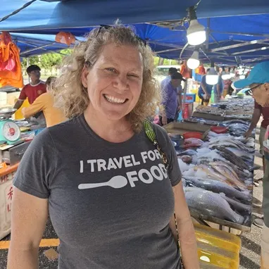 woman standing in a food market in malaysia