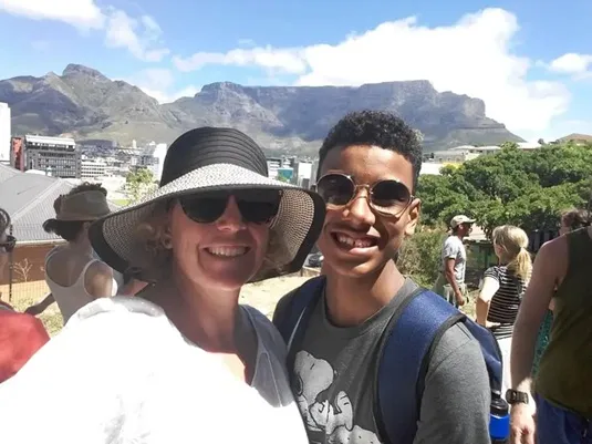 woman and young man posing with table mountain in background