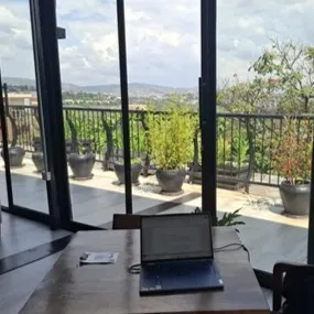 laptop on a table with a view of kigali